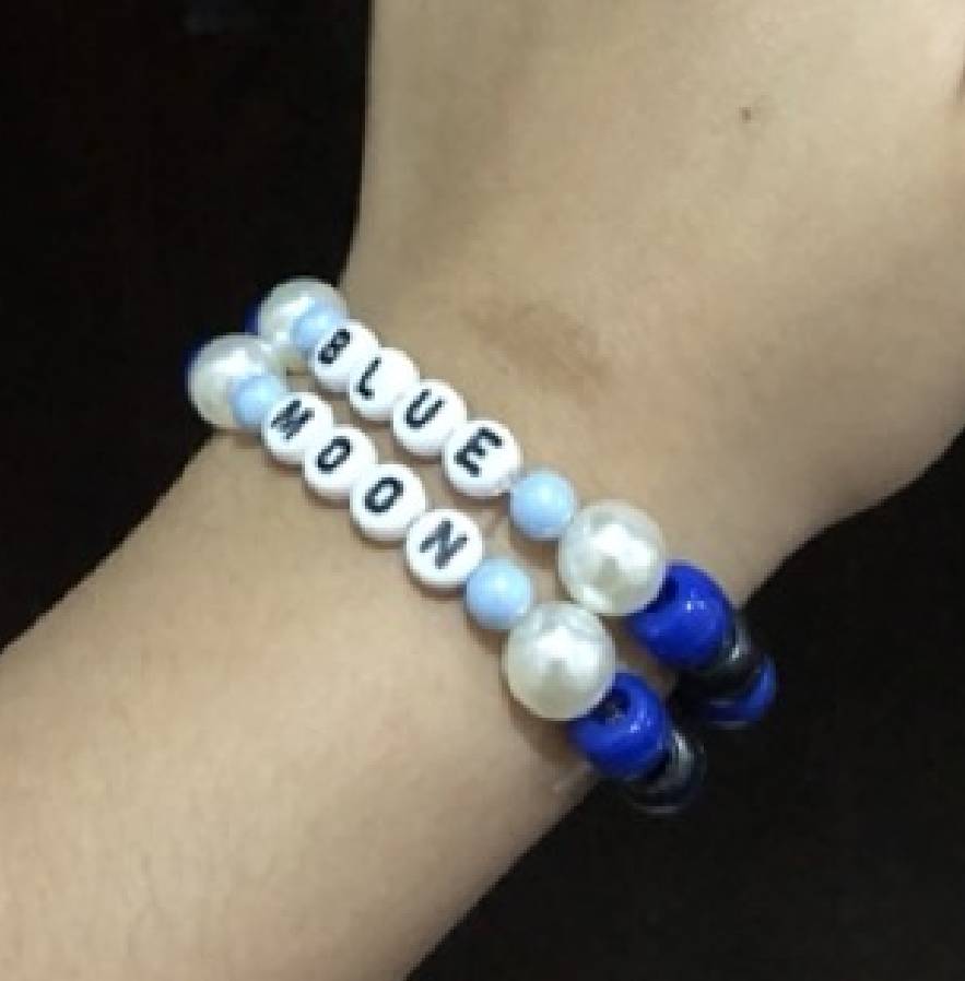 Two simple kandi singles that say 'BLUE' and 'MOON'.