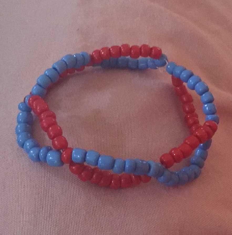 A kandi single made to look like most depictions of DNA: Two red and blue strands going around each other.