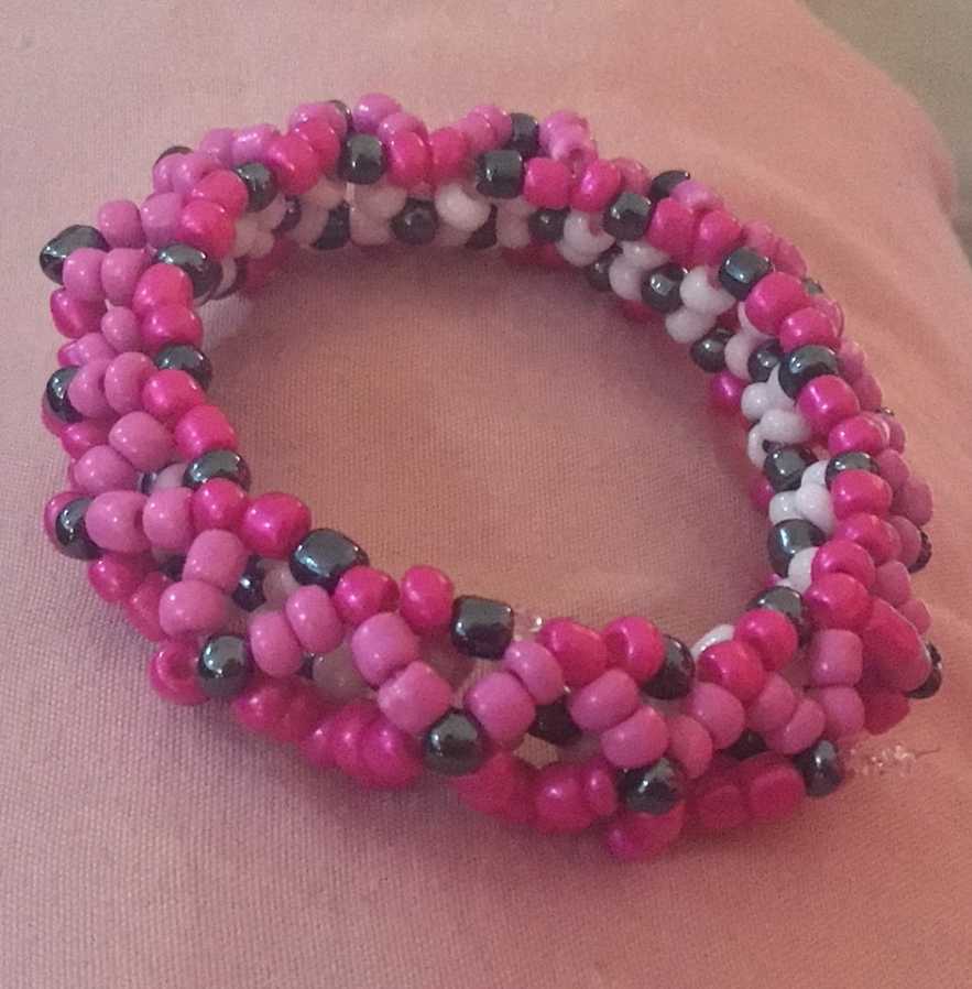 An attempt at a 3D cuff, with light pink beads in the inside, hot pink on the out, and pink beads when my dumbass ran out of them.